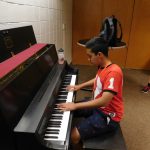 Student playing piano